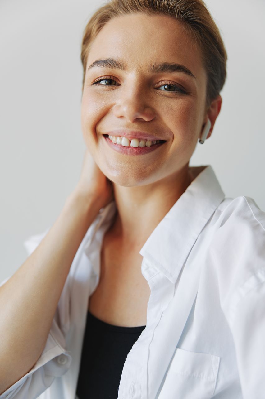 portrait of beautiful young woman against white background