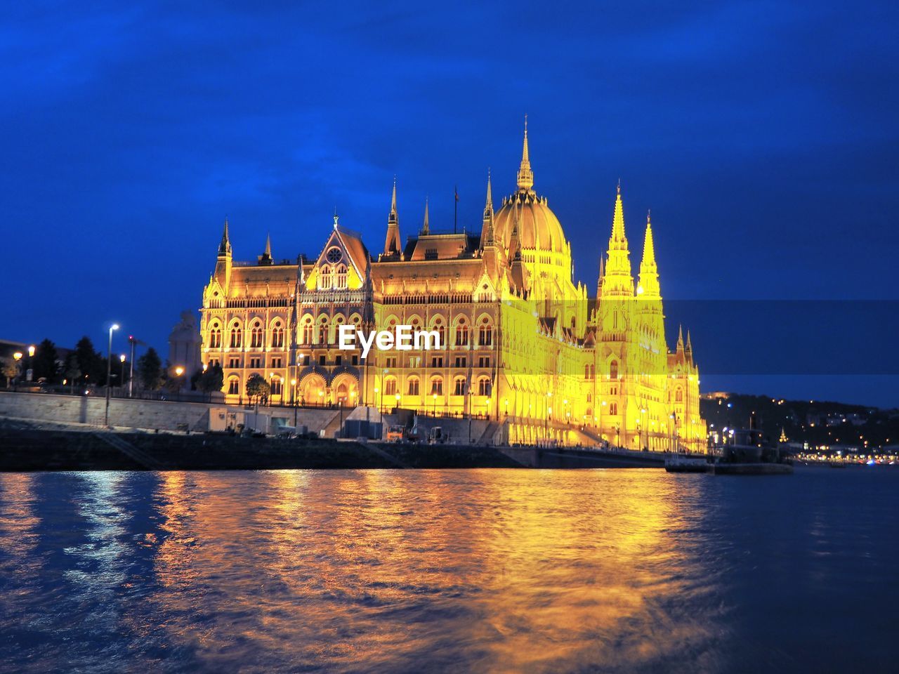 ILLUMINATED BUILDING AT WATERFRONT