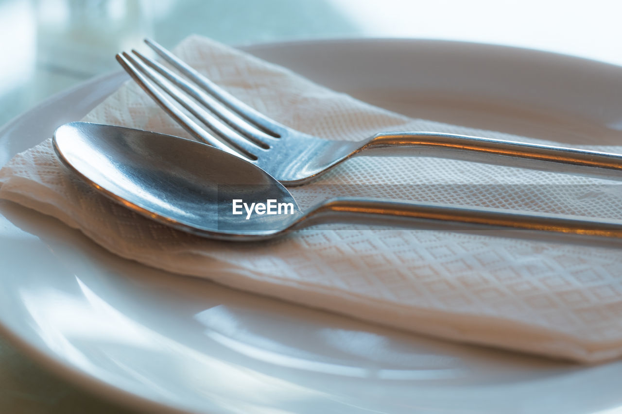 Close-up of eating utensils on table