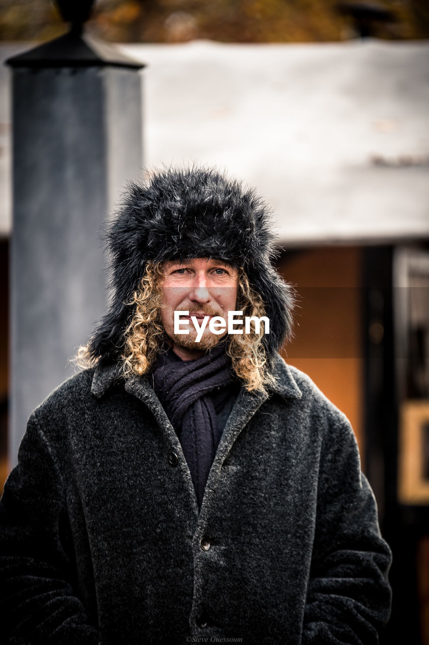 Mature man wearing warm clothing while standing outdoors