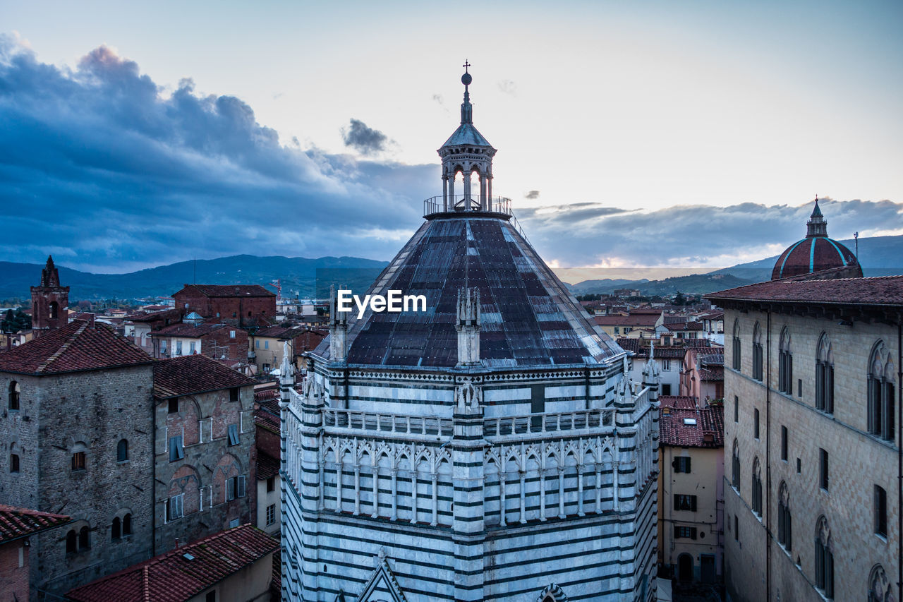 Aerial view of buildings in city against sky