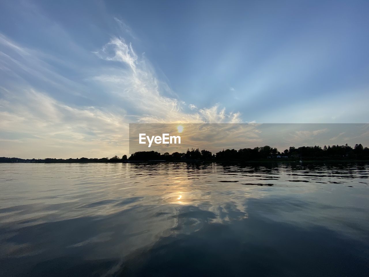 Scenic view of lake against sky during sunset