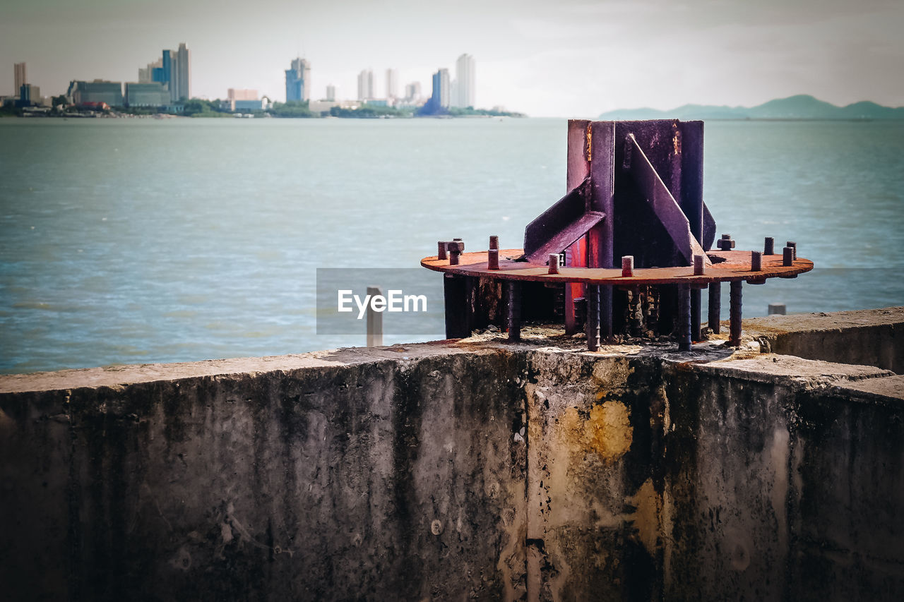 PIER ON SEA AGAINST BUILDINGS IN CITY