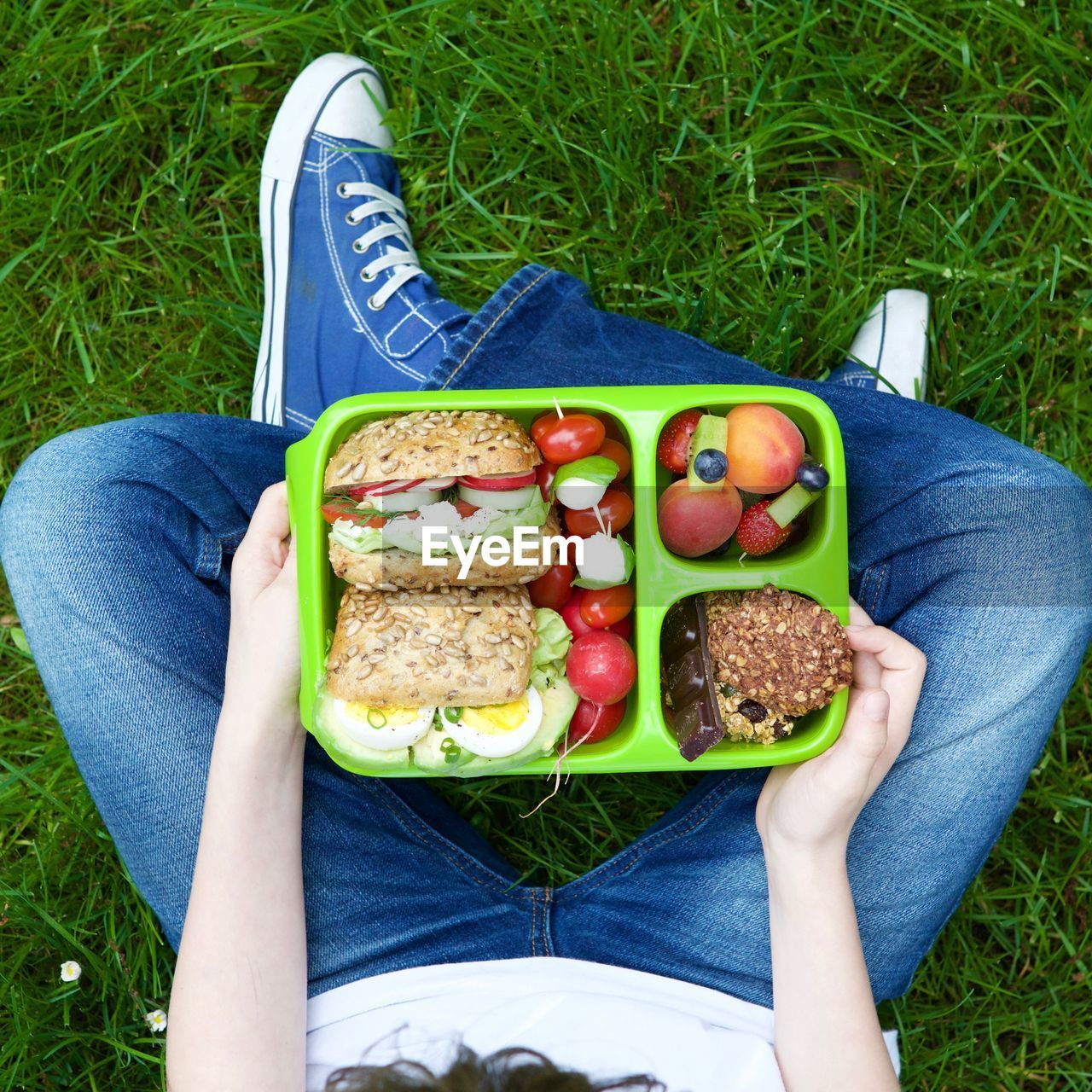 Low section of young man eating