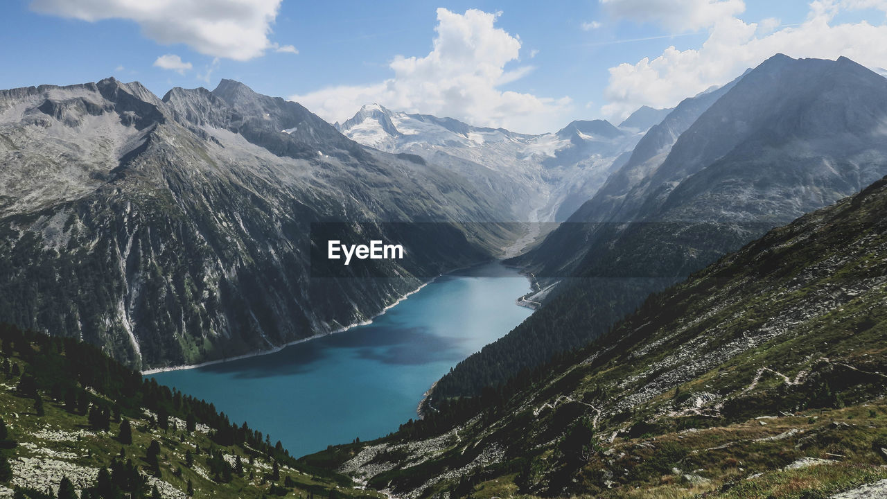 Scenic view of river with mountains in background