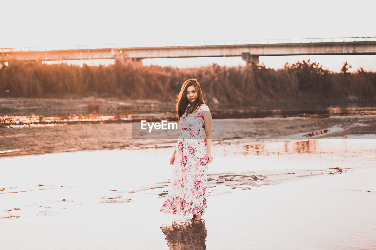 WOMAN STANDING IN WATER