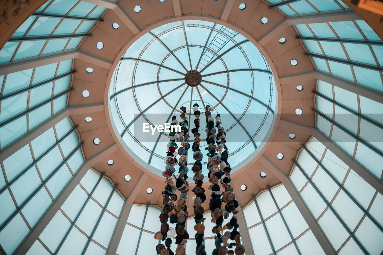 architecture, dome, built structure, low angle view, pattern, ceiling, indoors, shape, geometric shape, circle, group of people, day, glass, art, directly below, daylighting, travel destinations