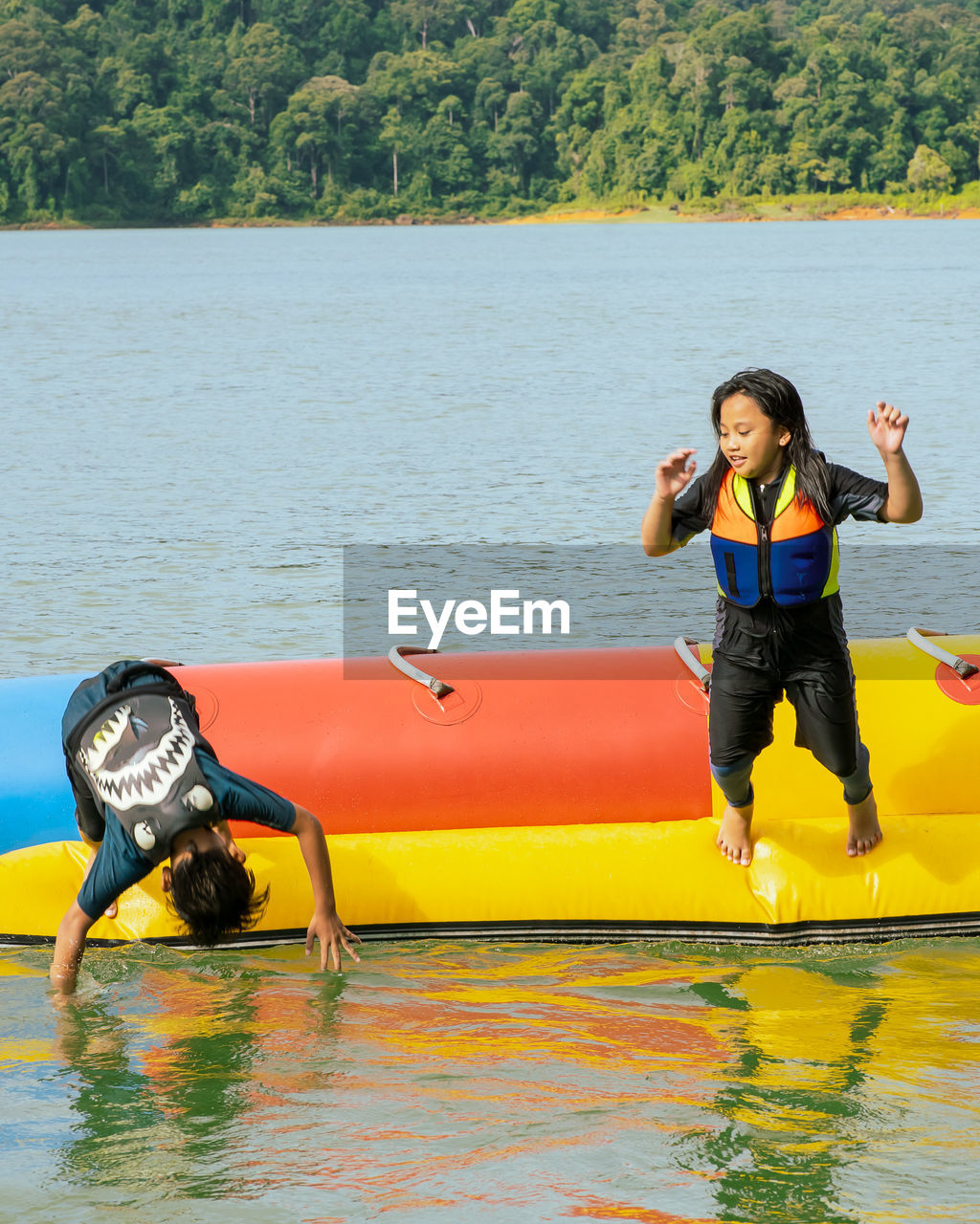 FULL LENGTH OF YOUNG WOMAN AT LAKE