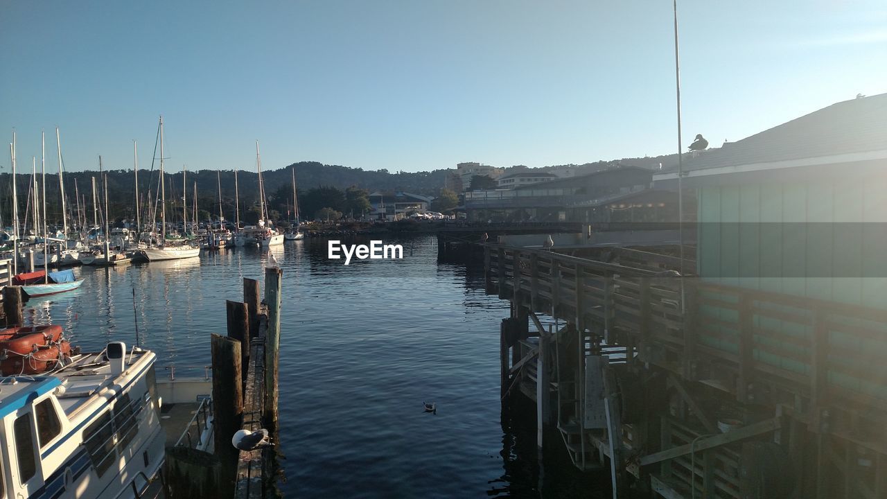 BOATS MOORED IN SEA