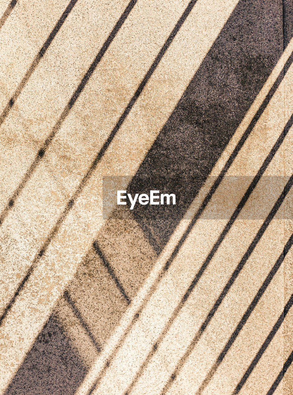 pattern, backgrounds, full frame, floor, line, sunlight, wood, no people, flooring, shadow, textured, high angle view, brown, day, road surface, striped, nature, outdoors, hardwood, repetition, footpath, close-up, soil, architecture, laminate flooring, asphalt, wall