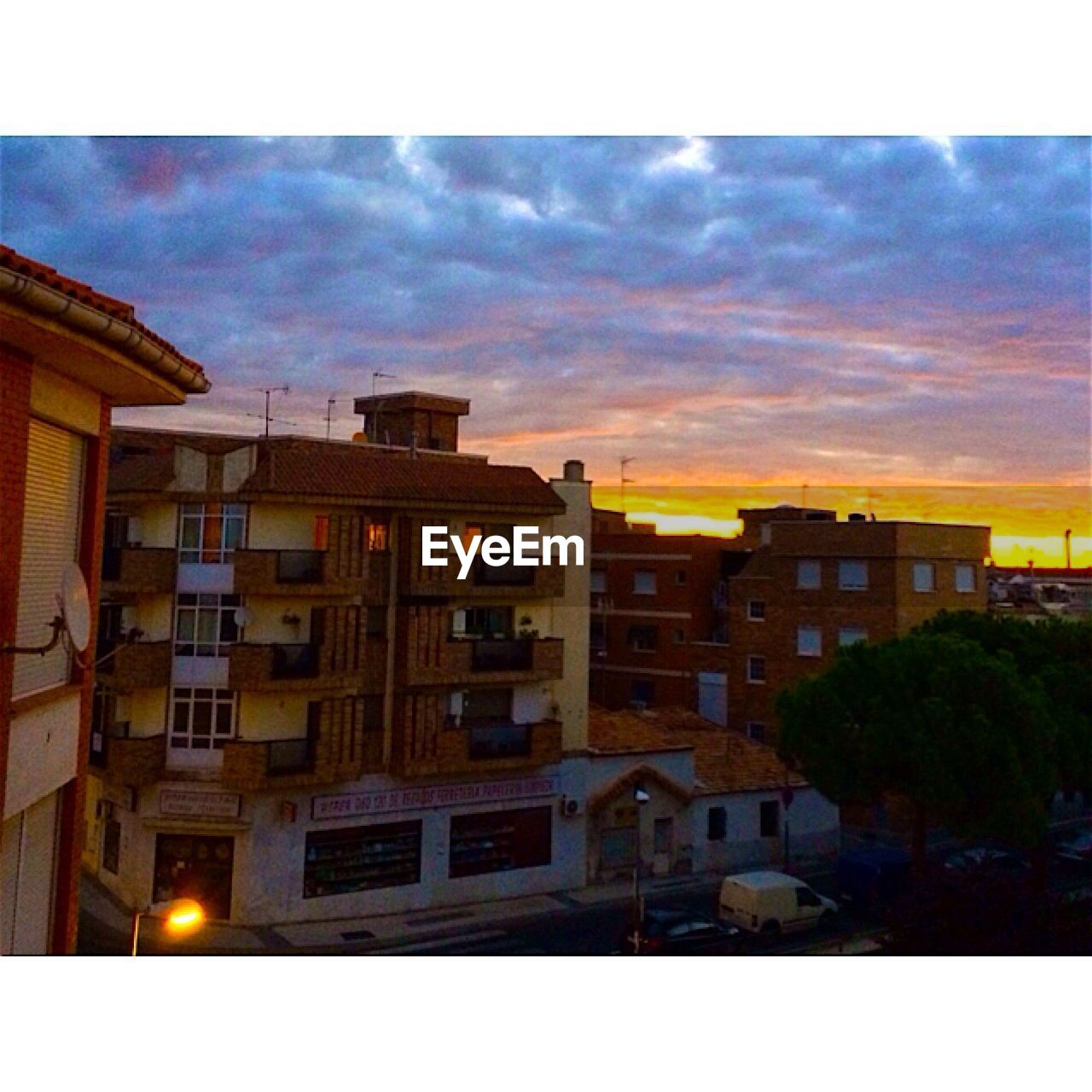 High angle view of residential building against sky during sunset