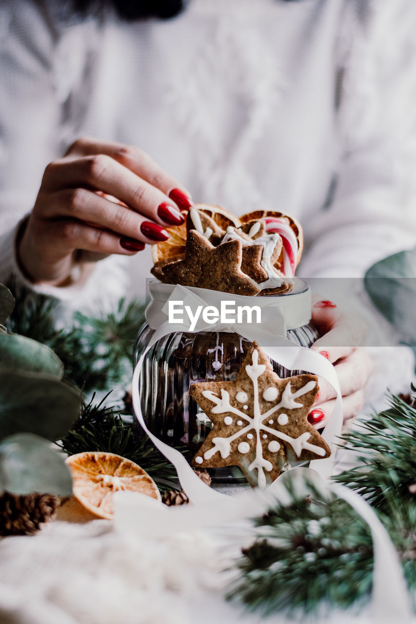 Midsection of woman holding dessert on table