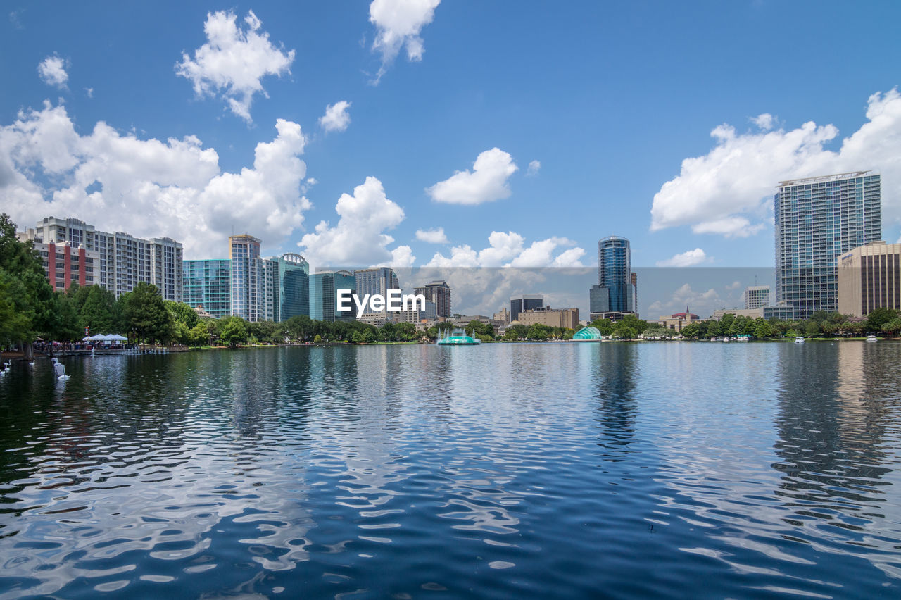 City by river against sky