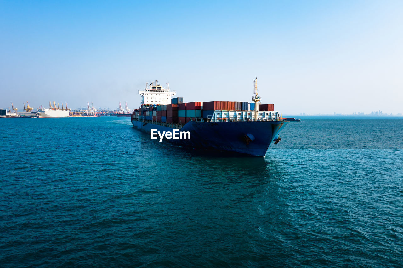 Container cargo ship carrying commercial container import export business delivery service 