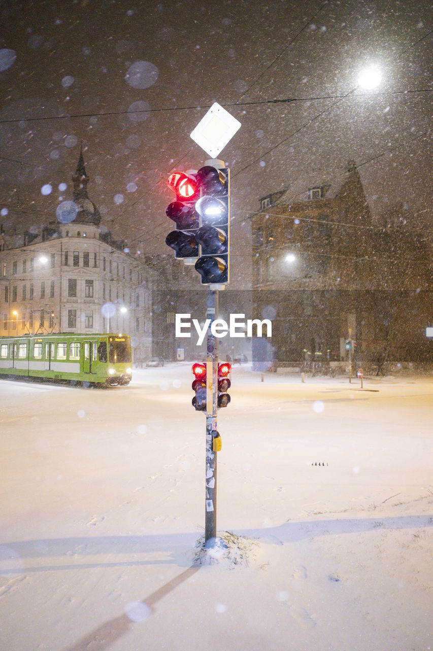 Illuminated street light on road at night