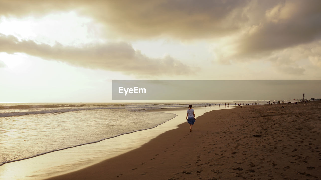 Full length of man on beach against sky