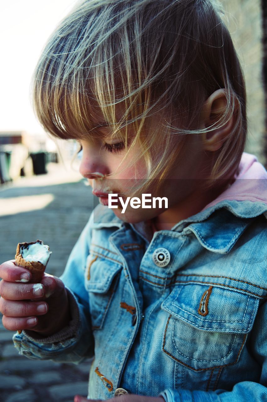 Close-up of girl having ice cream outdoors