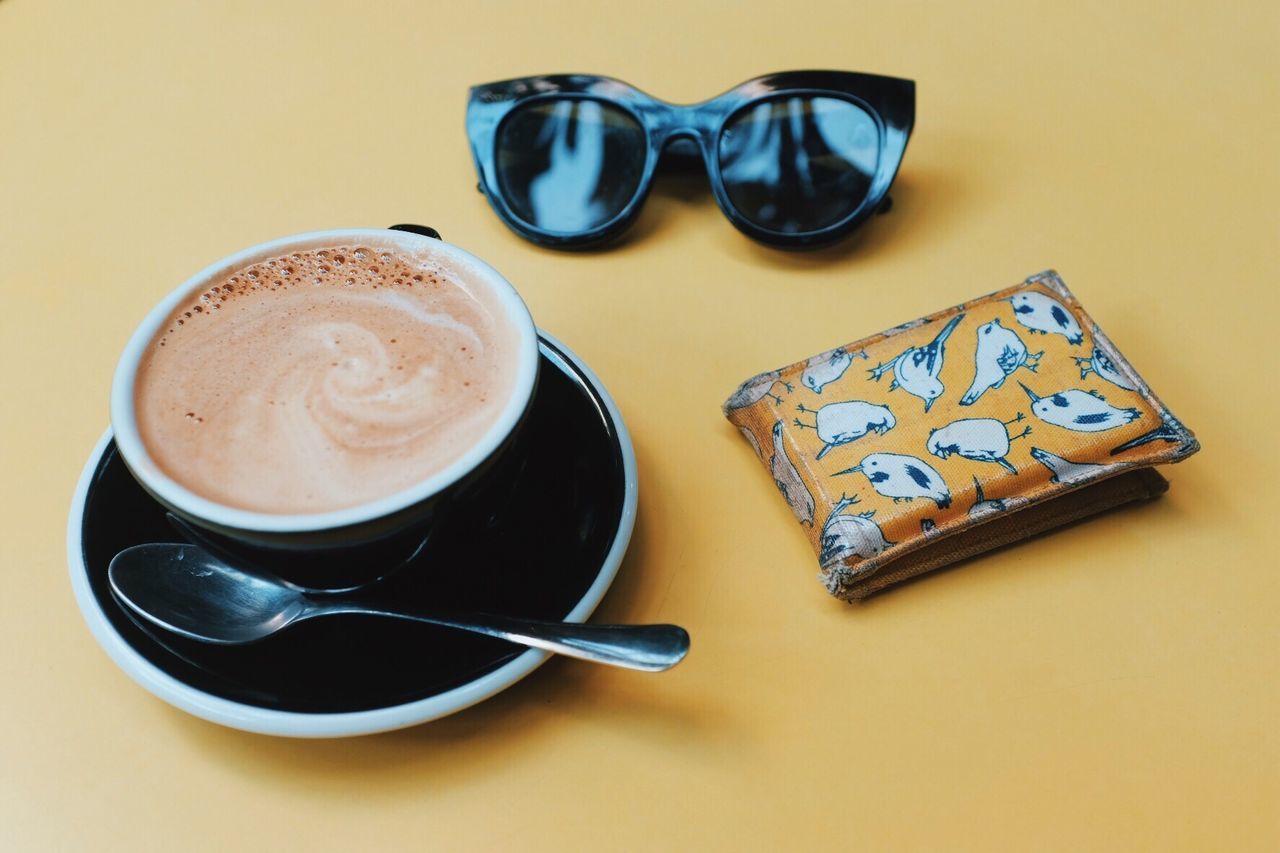 High angle view of coffee with wallet and sunglasses