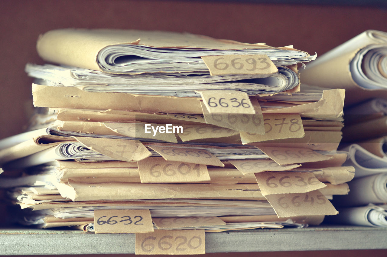 Close-up of labels on stacked filed in office