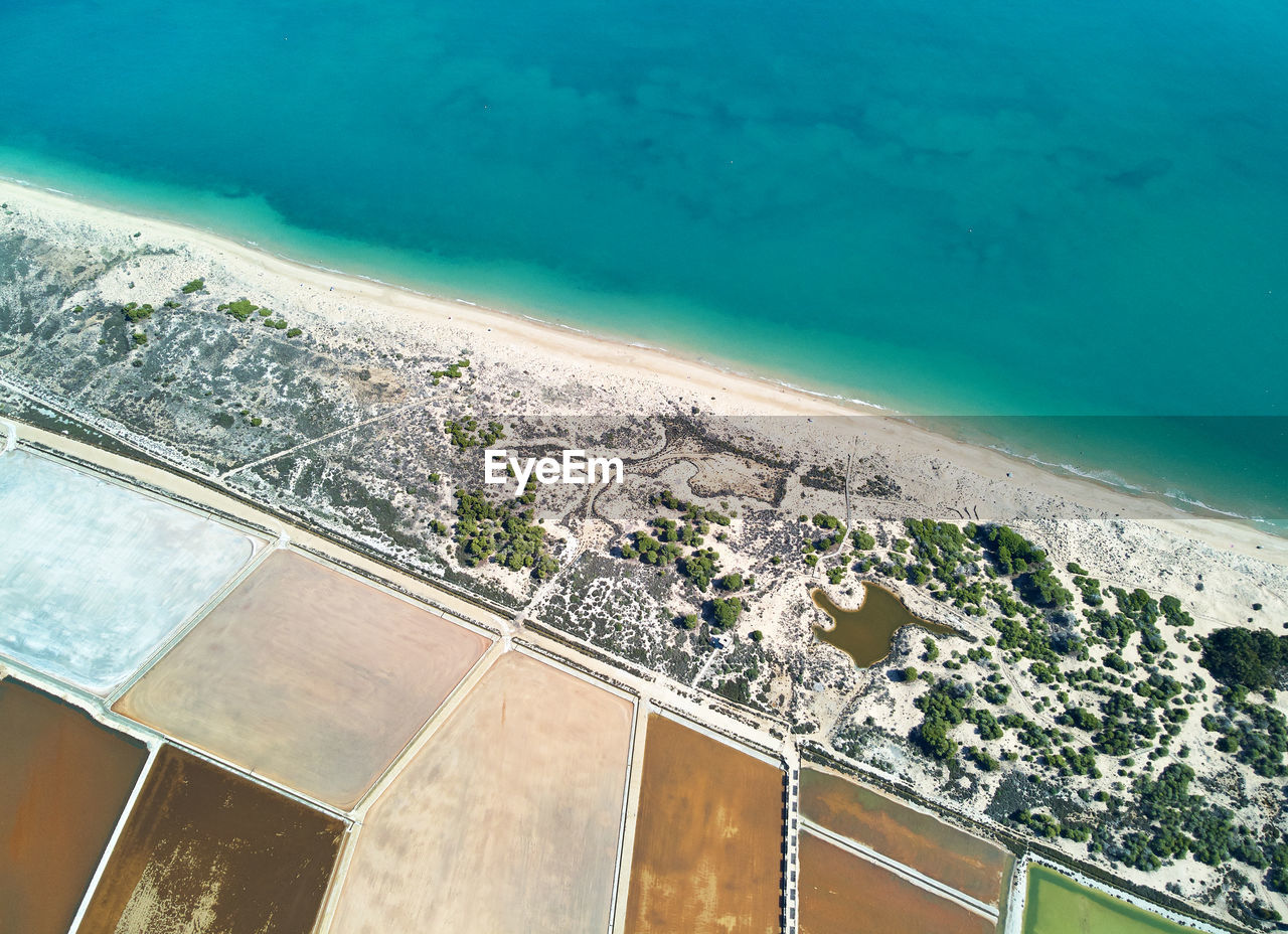 Aerial view of salt pans and sea