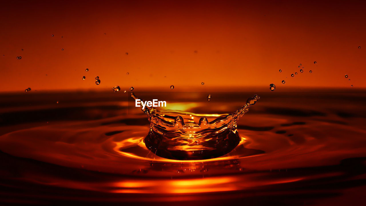 CLOSE-UP OF WATER SPLASHING ON GLASS