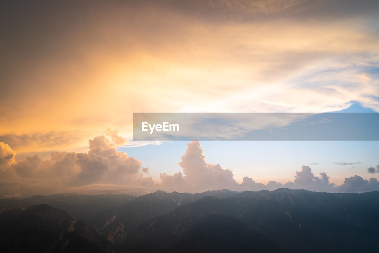 Scenic view of silhouette mountains against sky at sunset