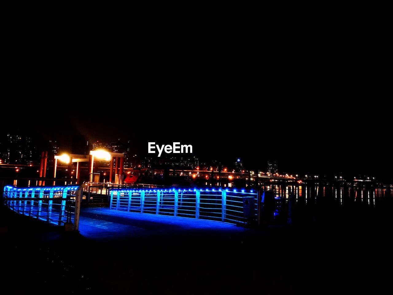 ILLUMINATED CITY AGAINST CLEAR SKY AT NIGHT