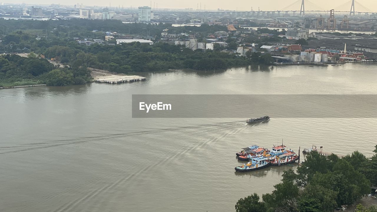 water, nautical vessel, transportation, river, mode of transportation, architecture, high angle view, nature, ship, vehicle, built structure, building exterior, boat, city, day, outdoors, waterway, tree, no people, watercraft, travel, plant, sky, travel destinations, building, aerial view, harbor