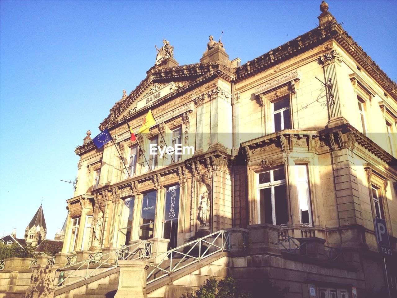 Low angle view of building against clear blue sky