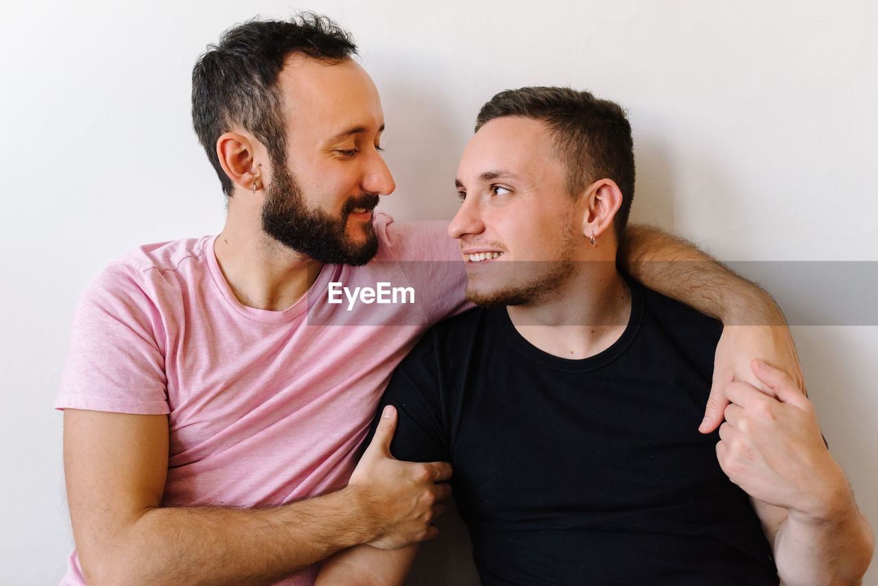Gay couple laughing at home.