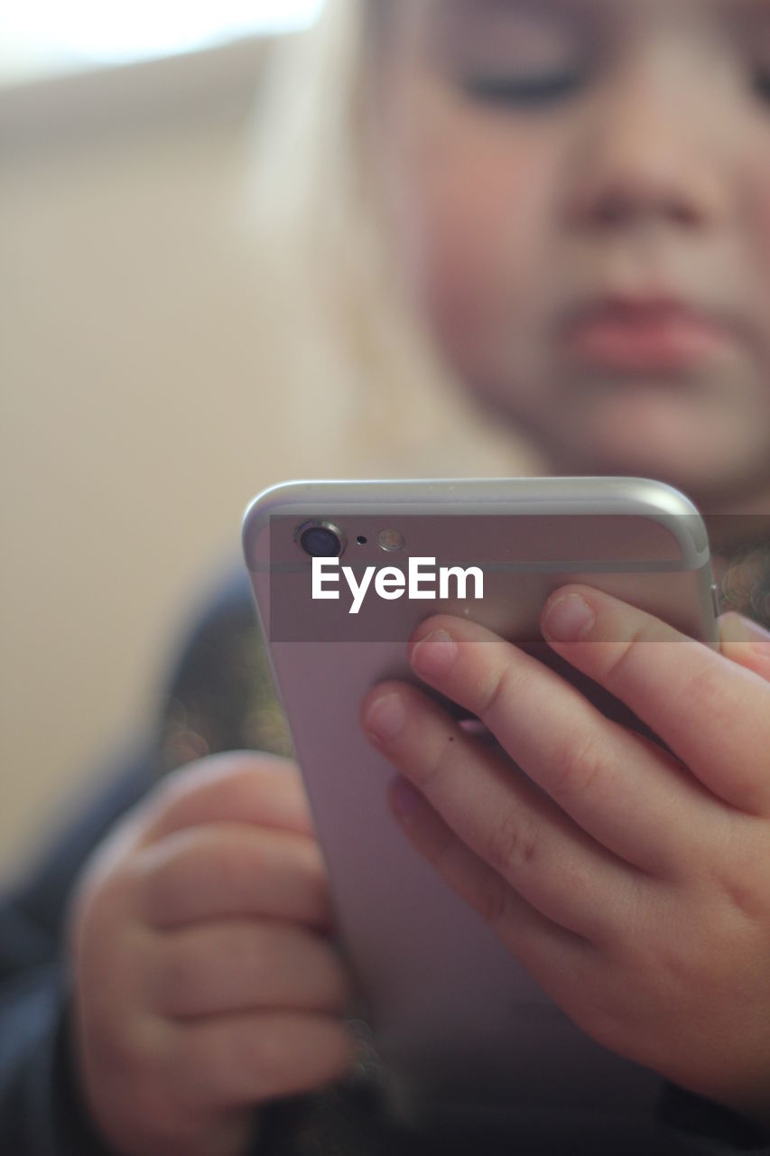 Close-up of girl using smart phone