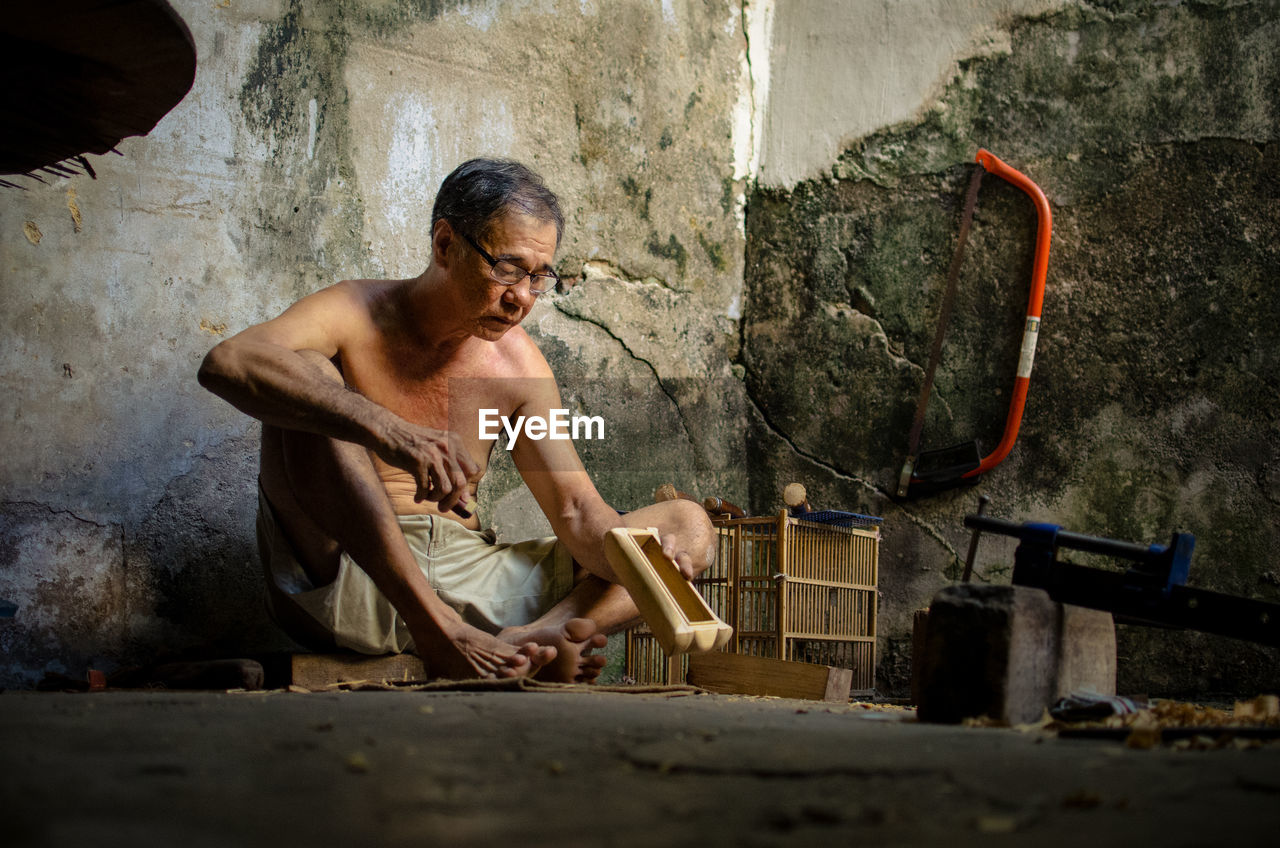 Portrait of shirtless man working