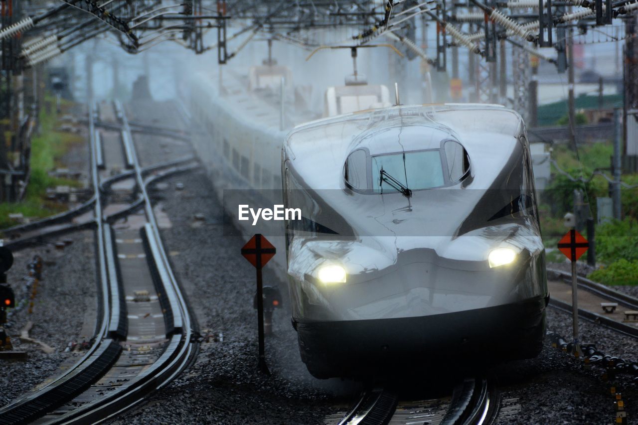 Shinkansen n700s passing through maibara station in the rain