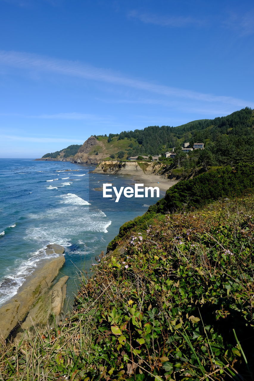 SCENIC VIEW OF BEACH AGAINST BLUE SKY