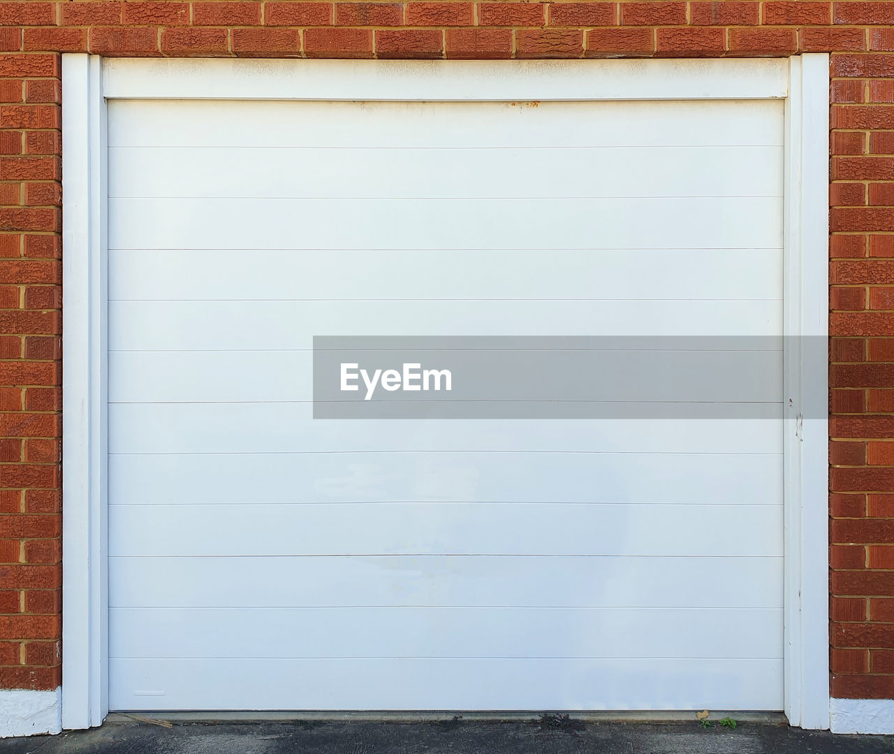 architecture, door, garage door, built structure, brick, brick wall, building exterior, wall - building feature, wall, window covering, copy space, entrance, closed, white, no people, shutter, wood, building, city, day, facade, interior design, garage, empty, window, business