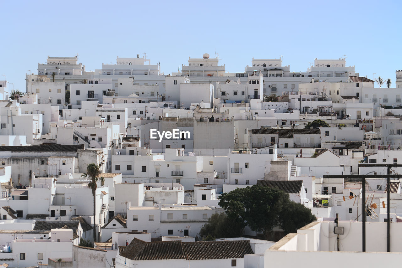 Buildings in city against clear sky