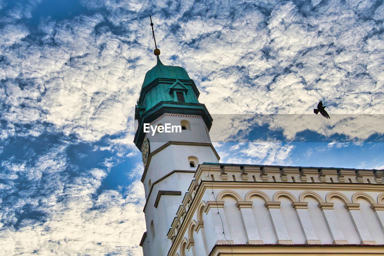 LOW ANGLE VIEW OF A BUILDING WITH CHURCH AGAINST SKY