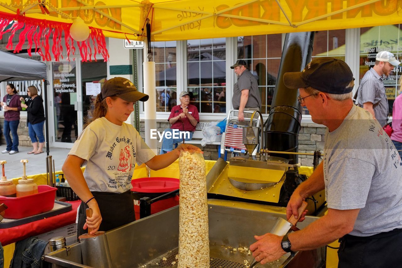 PEOPLE AT MARKET STALL