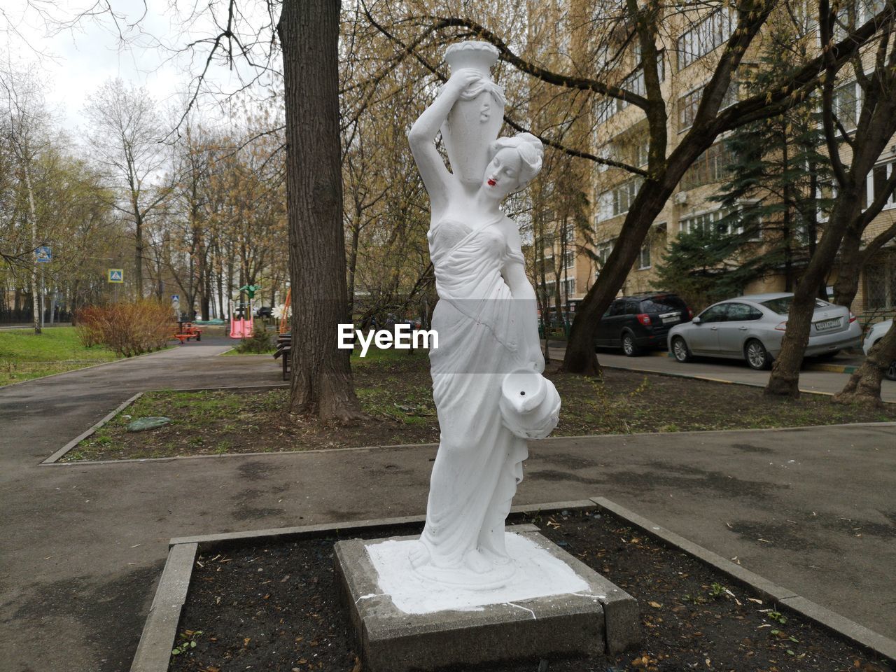 STATUE IN PARK BY CITY STREET