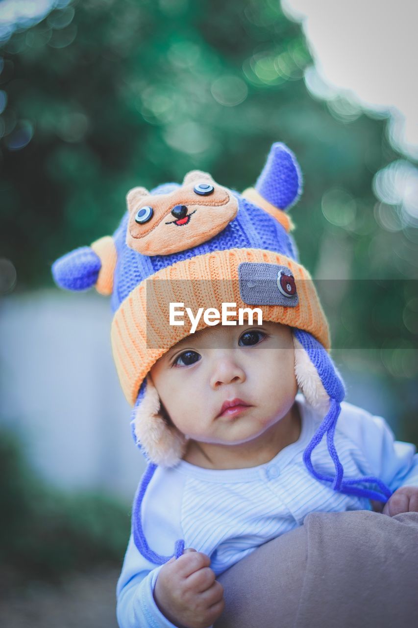 Portrait of cute baby girl against defocused background