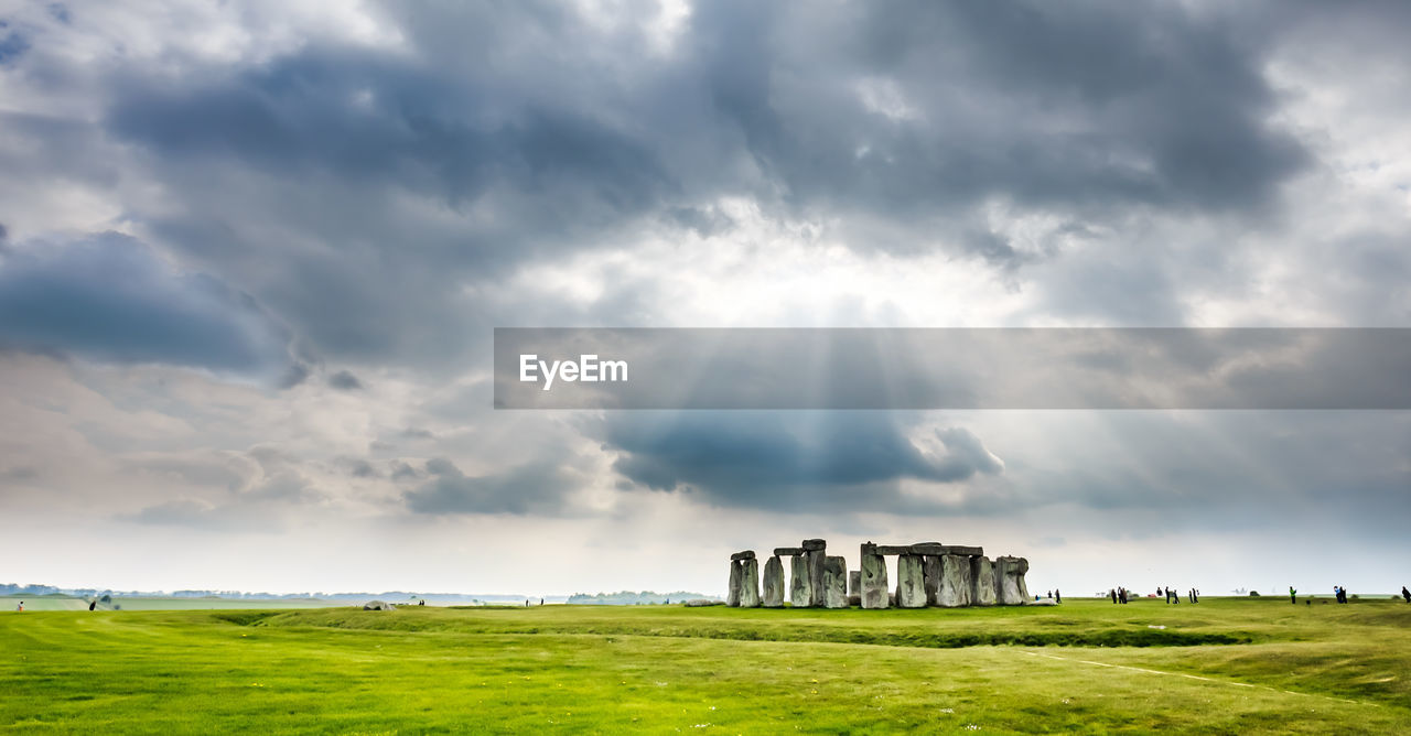 Old ruins on field against sky