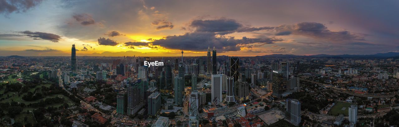 High angle view of modern buildings against sky during sunset