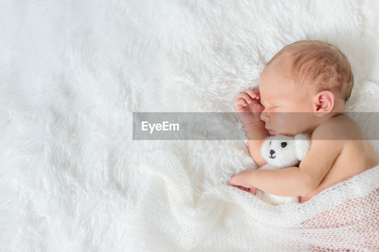 Cute baby girl sleeping on bed