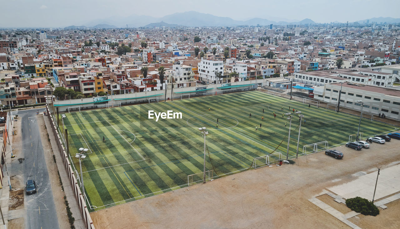 Aerial view of the football field in the middle of a messy neighborhood, callao, lima. peru