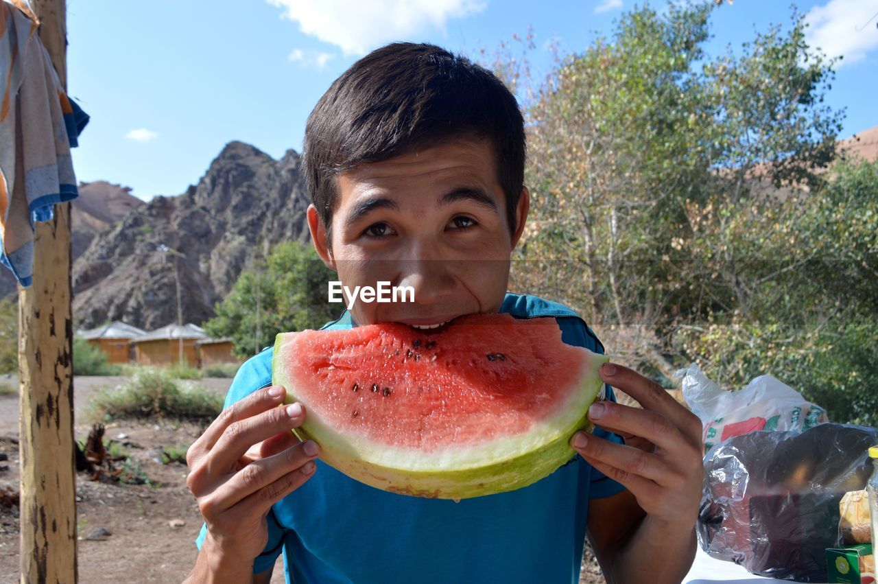 Teenager eating watermelon