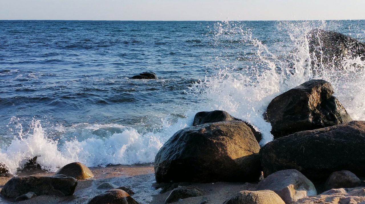 Sea waves splashing on rocks