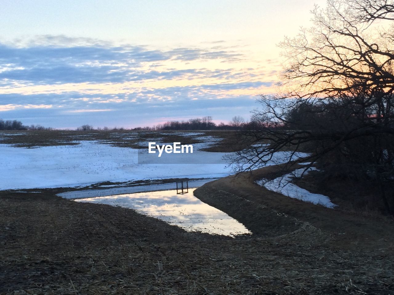 View of frozen lake against scenic sky