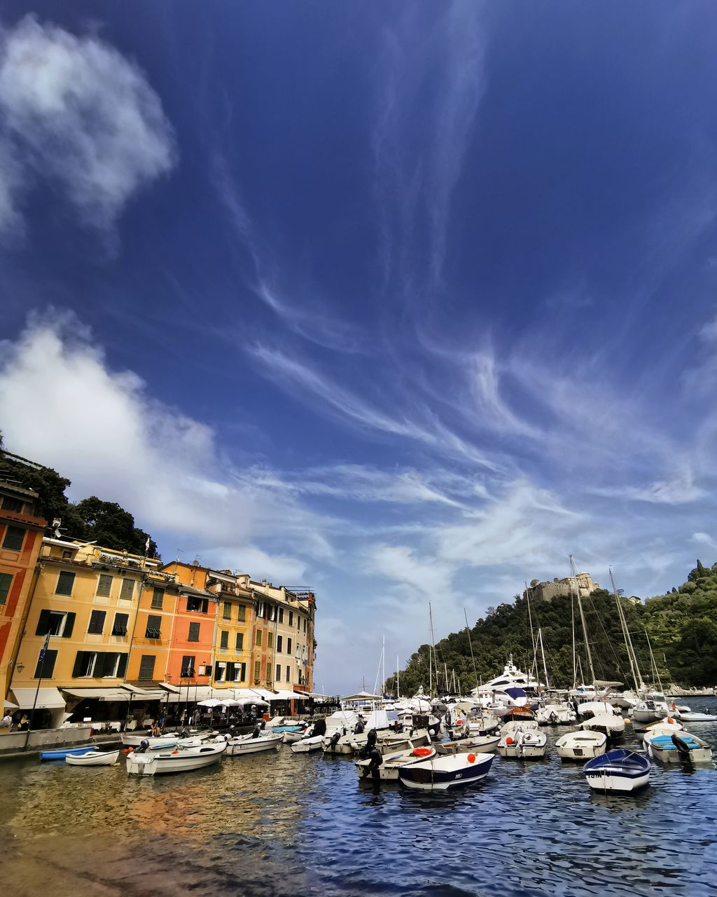 SAILBOATS MOORED IN SEA AGAINST SKY