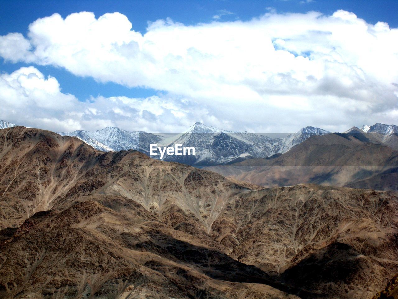 Scenic view of mountains against cloudy sky