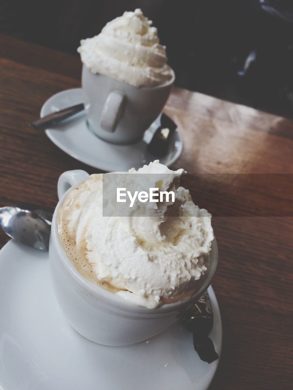 Coffee with whipped cream on table